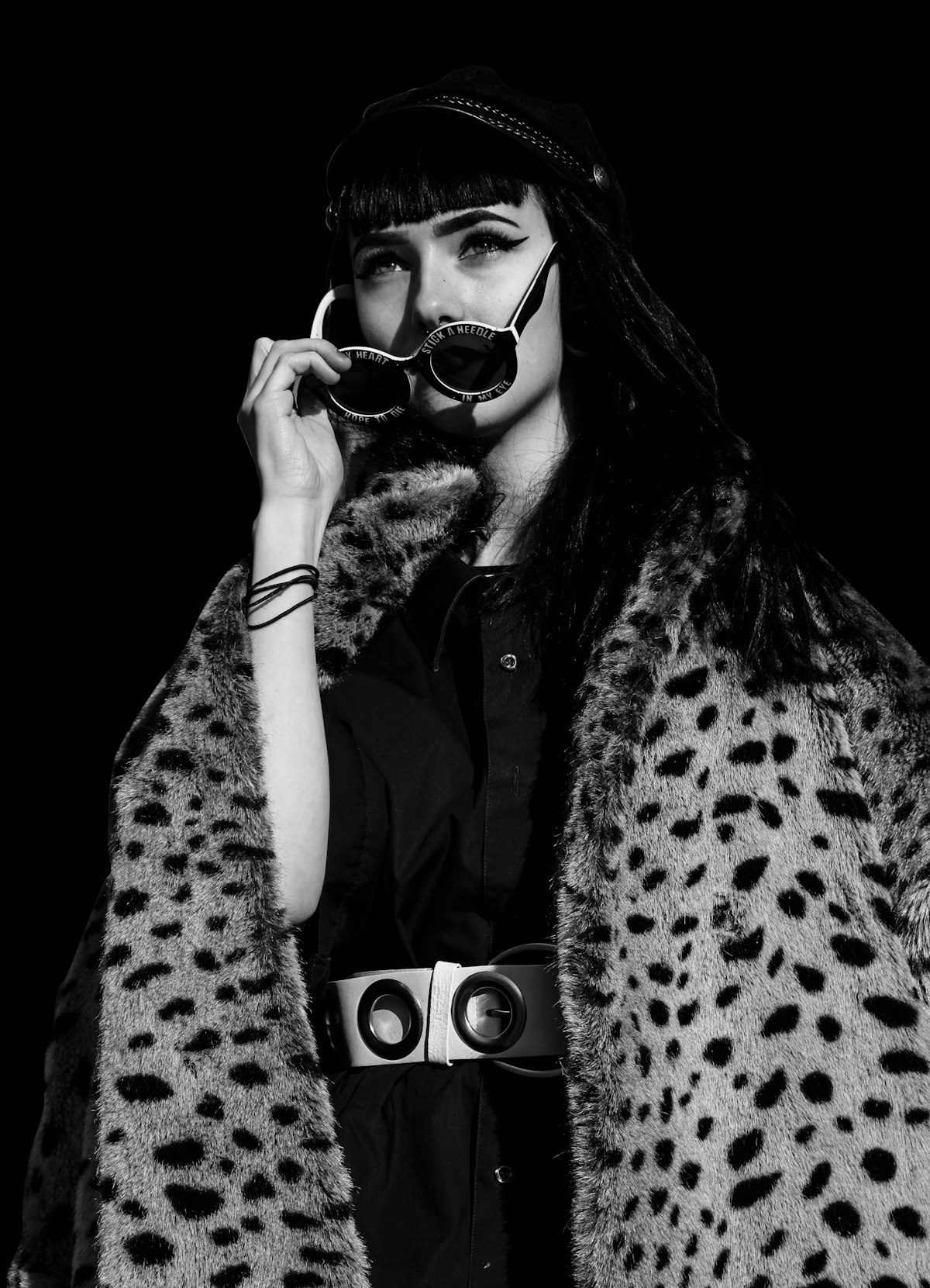 Woman wearing a leopard-print coat and sunglasses