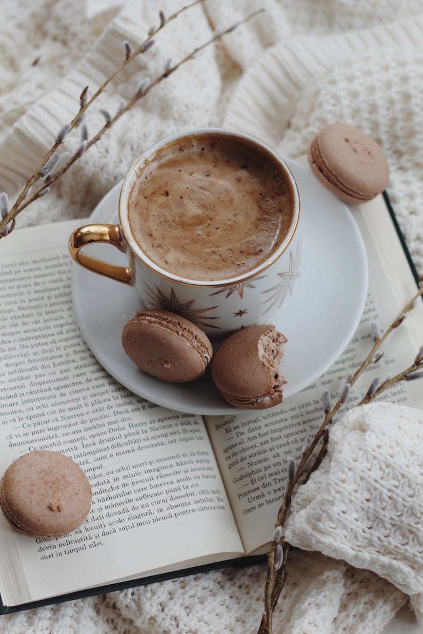 macaroons and coffee cup on book