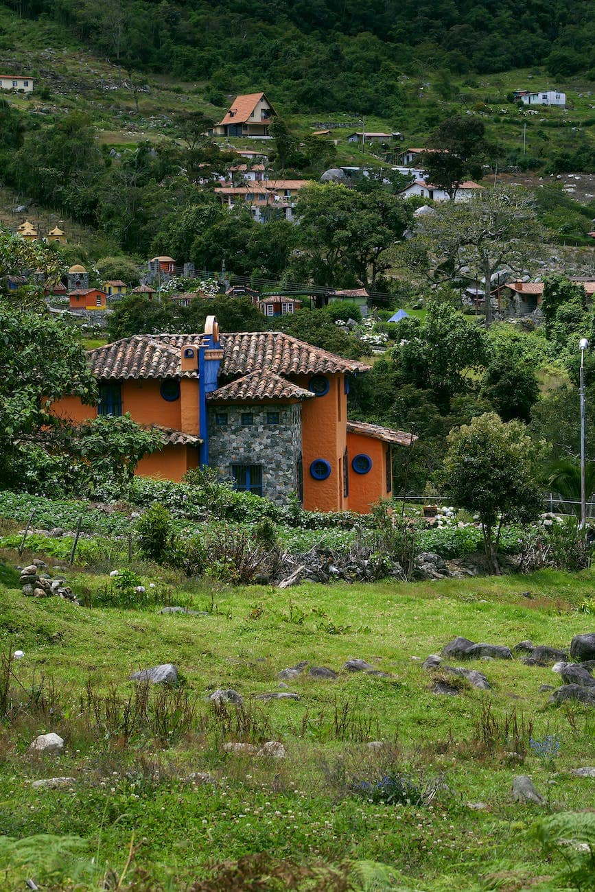 brown and white concrete house on green grass field