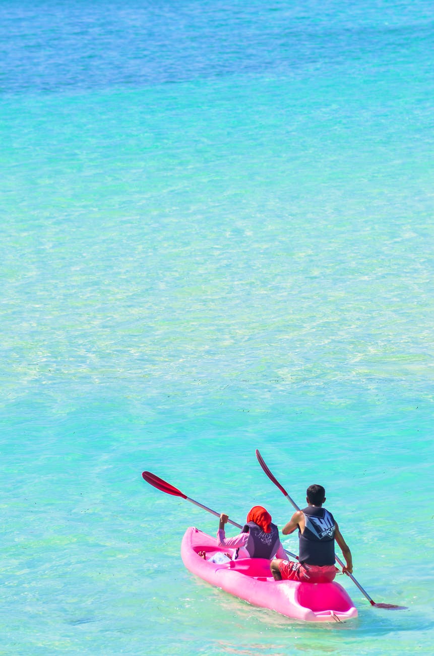 photo of people in pink kayak