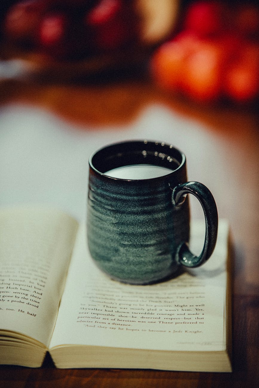 a mug sits on top of an open book