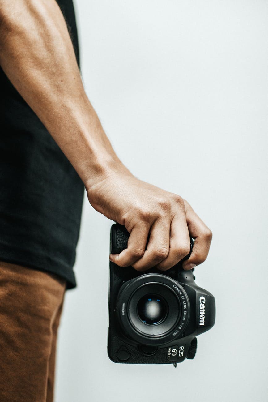 person holding canon dslr camea