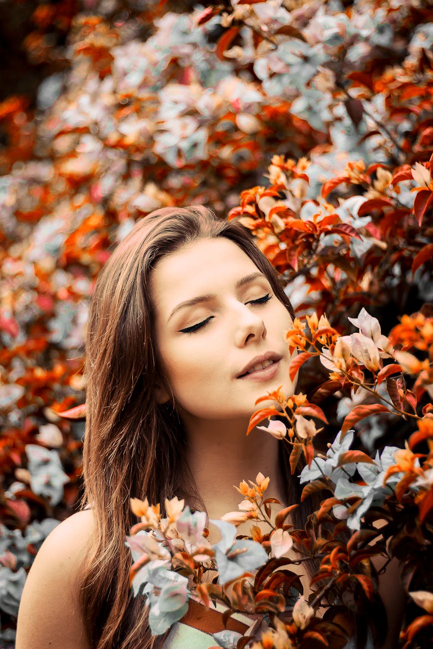 close up photo of woman near flowers