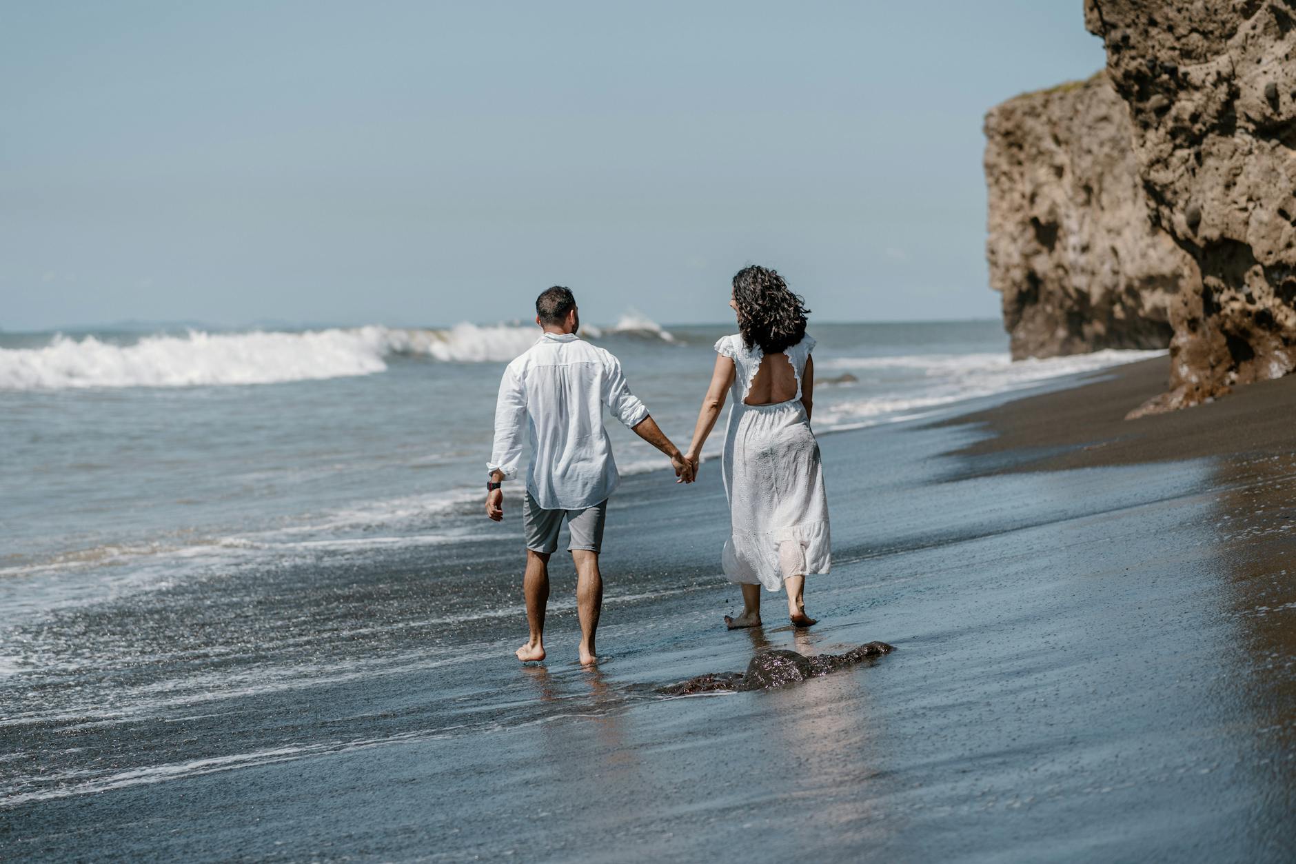 couple walking on beach in summer