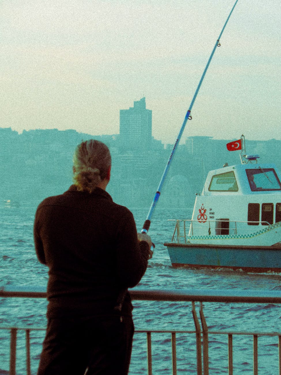 fisherman and motorboat on sea shore in istanbul