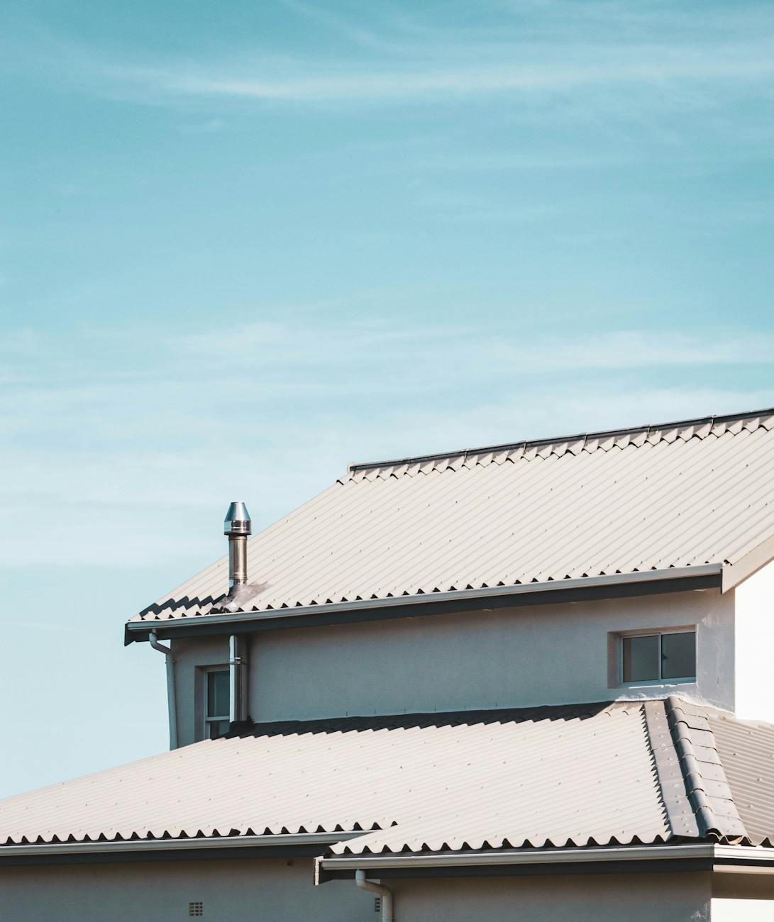 white roof of house under blue sky