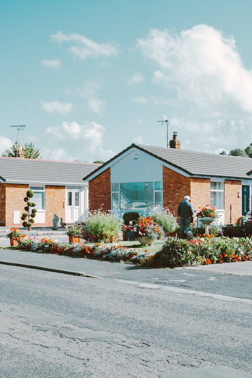 brown white and gray houses near road