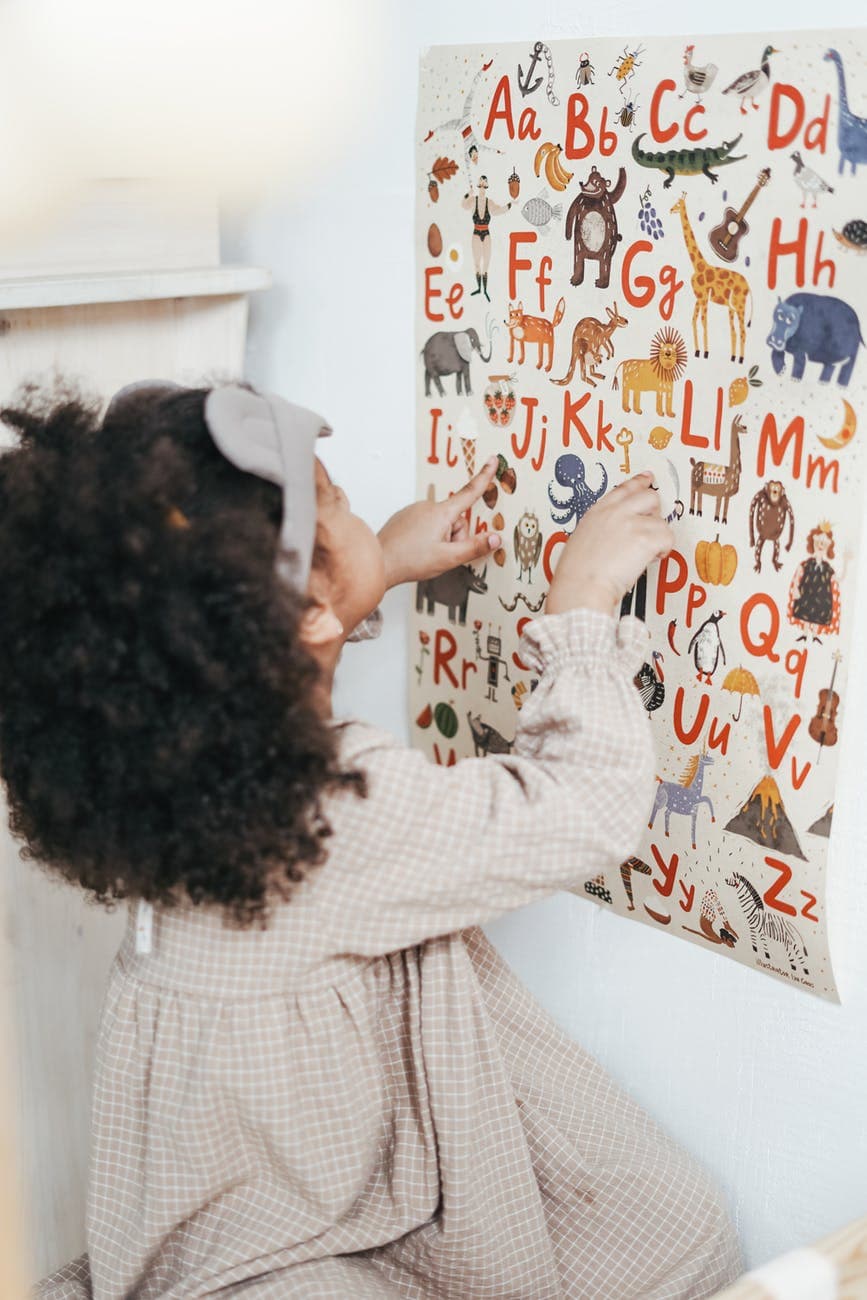 girl reading english alphabet