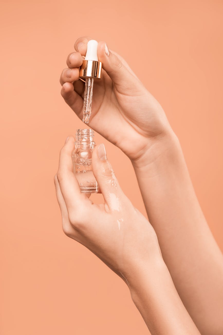 person holding serum bottle
