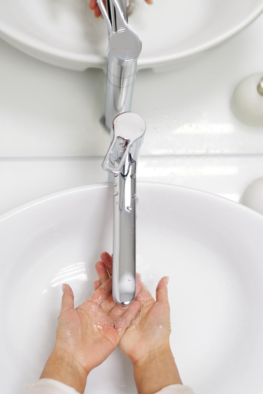 woman washing her hands with soap