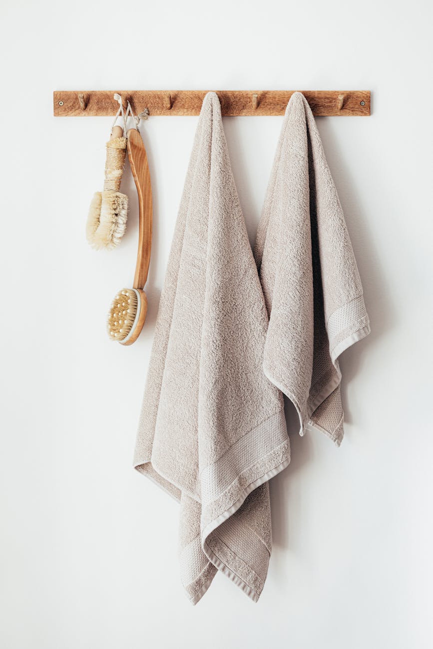 wooden hanger with towels and body brushes