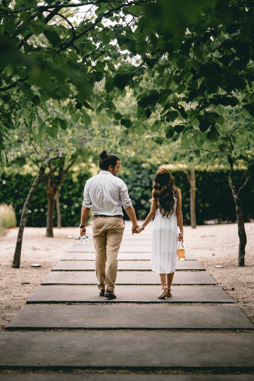 man and woman walking on pathway