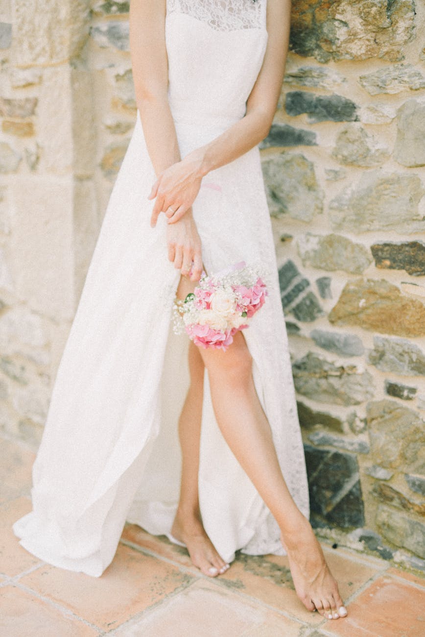 person standing while holding bridal bouquet