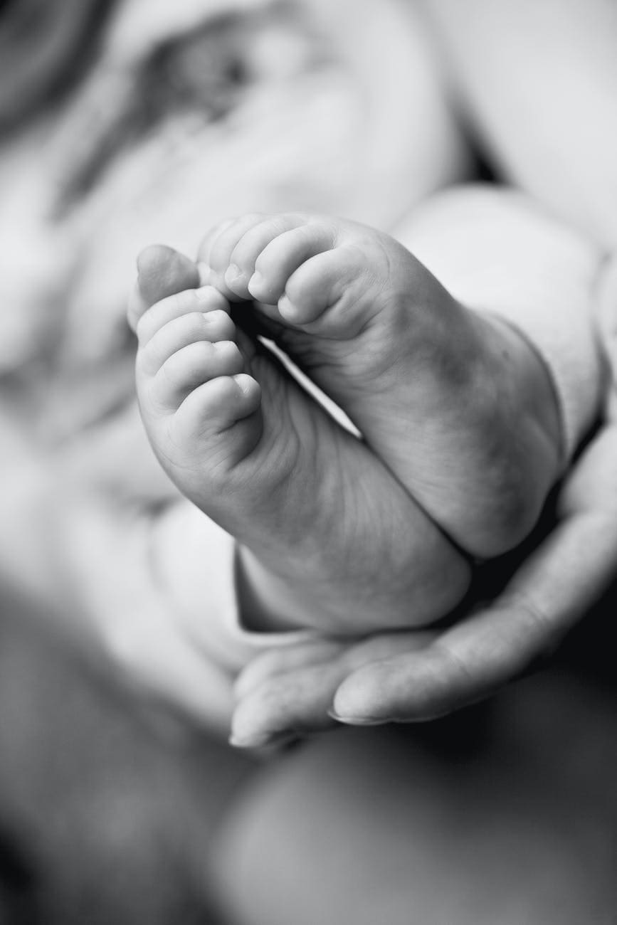 grayscale photo of babys feet