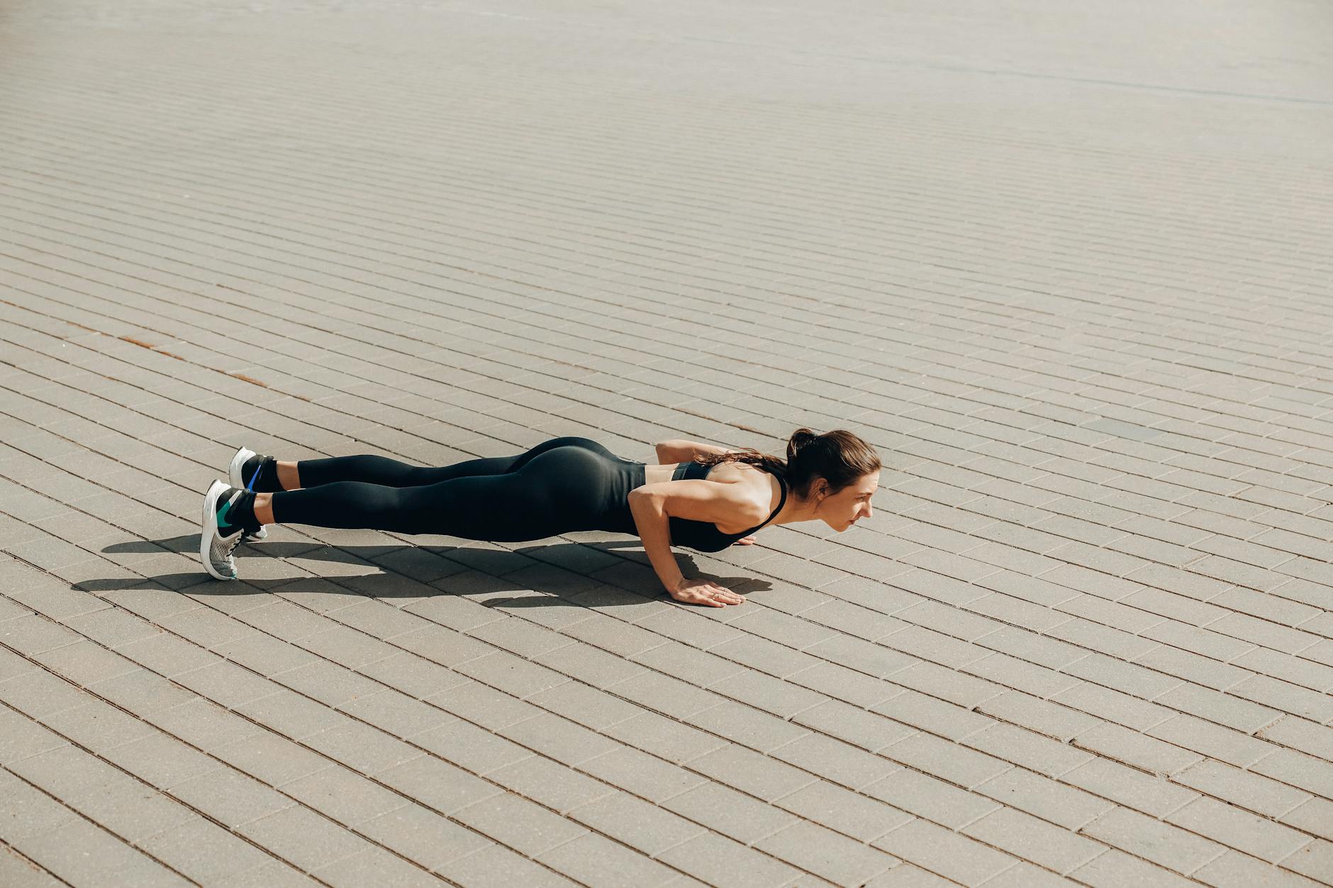 a woman in activewear doing push ups