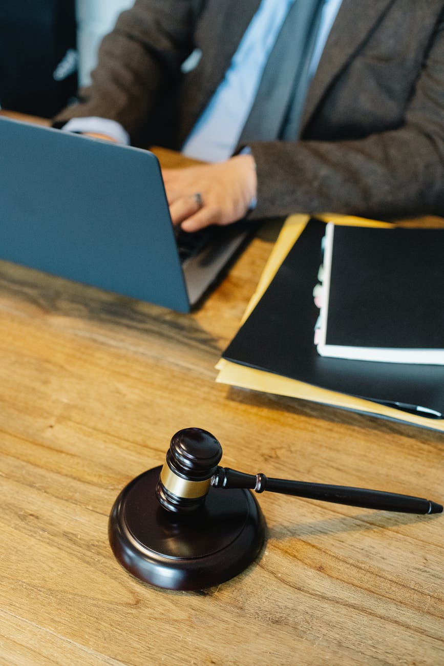 unrecognizable man working on netbook in law office