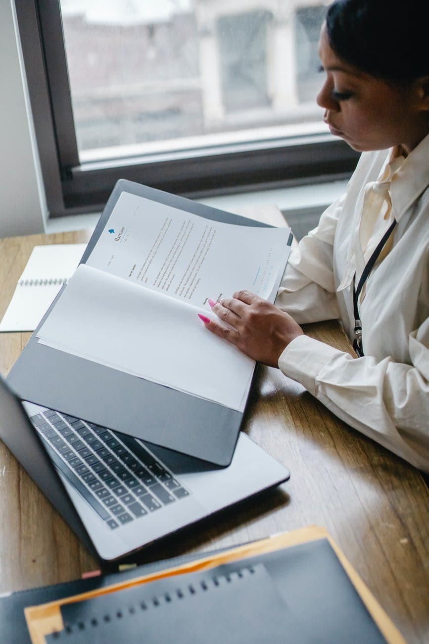black woman working with documents in office