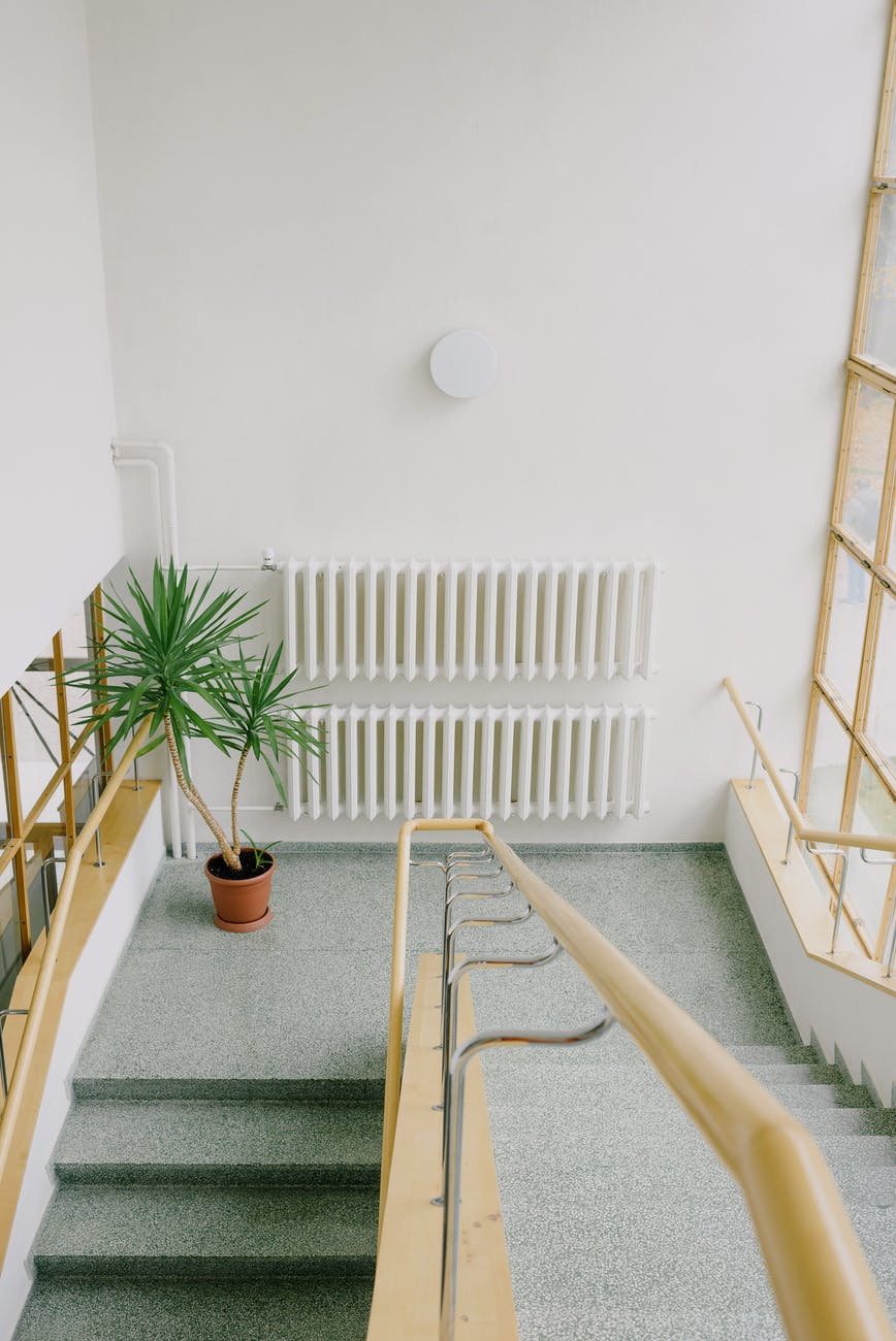 staircase with metal railings in multistory house