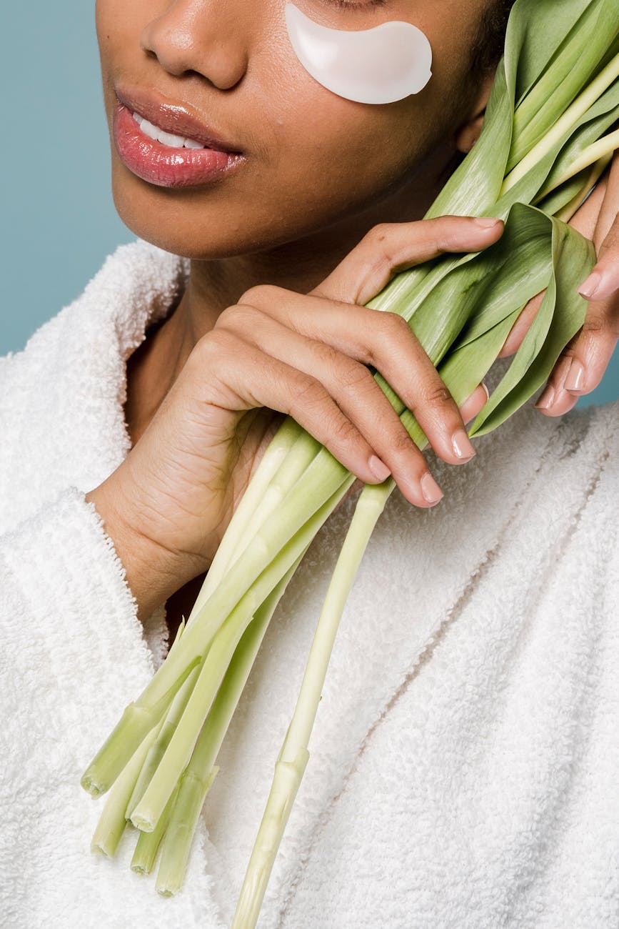 black woman with eye patches and fresh green flowers