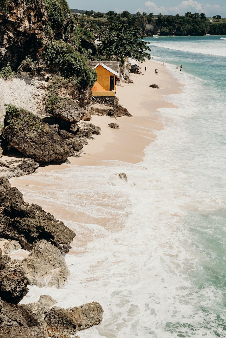 waves crashing the white beach shore