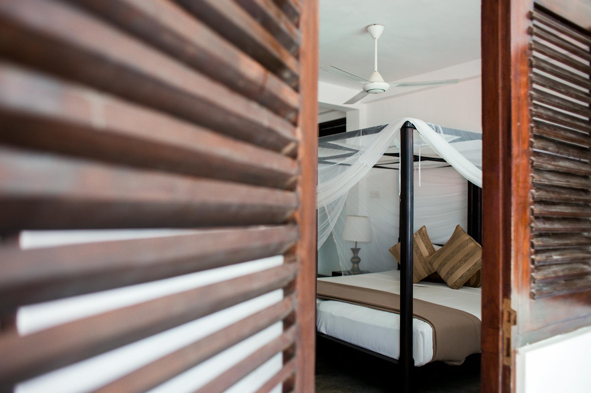 black bed frame with white bed linen