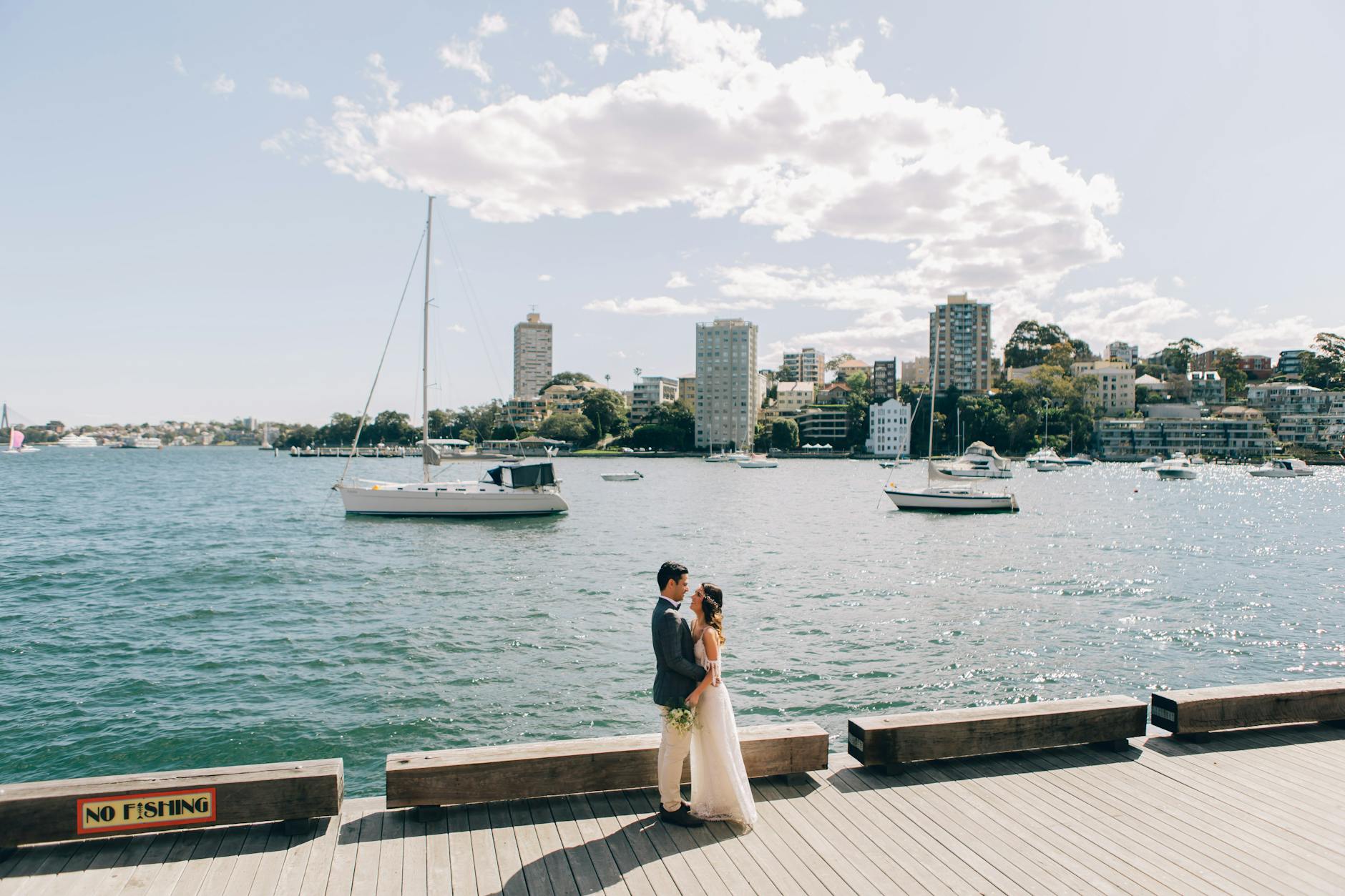 man in blue blazer touching the hips of woman in wedding dress