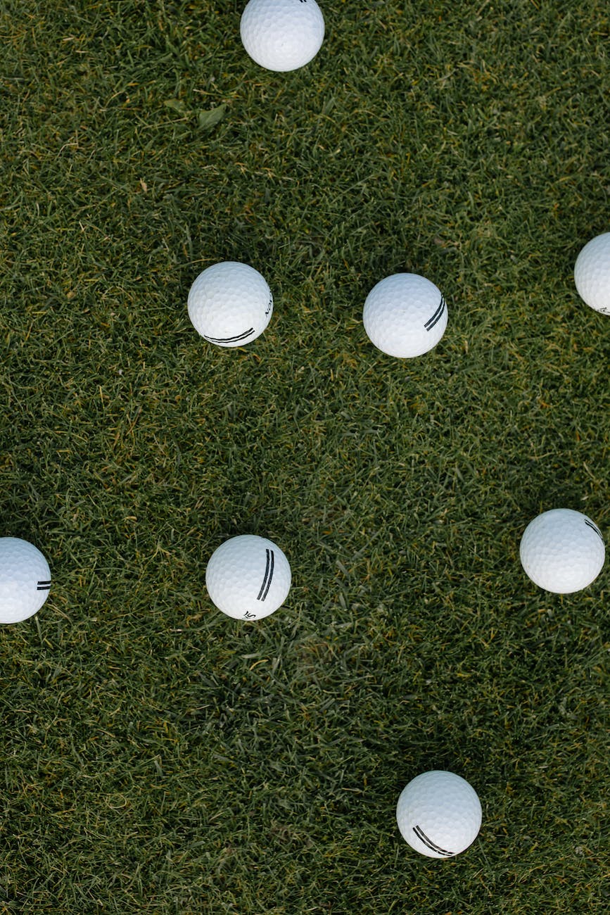 white golf balls on green grass field