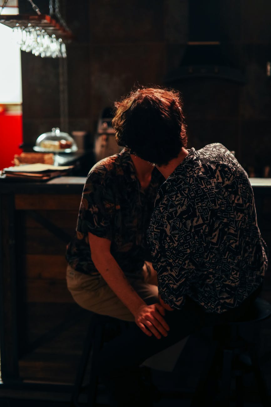 a couple kissing at the bar