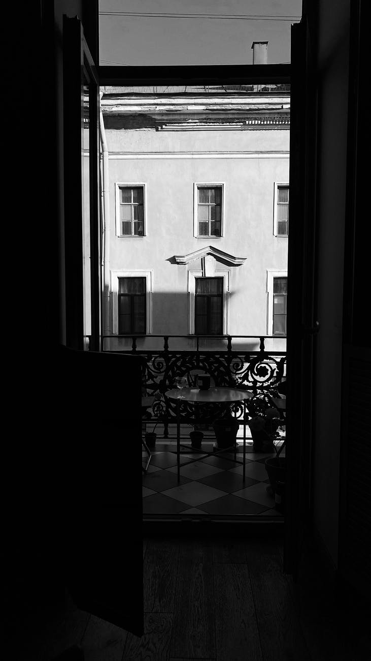 from dark room view of balcony against residential building