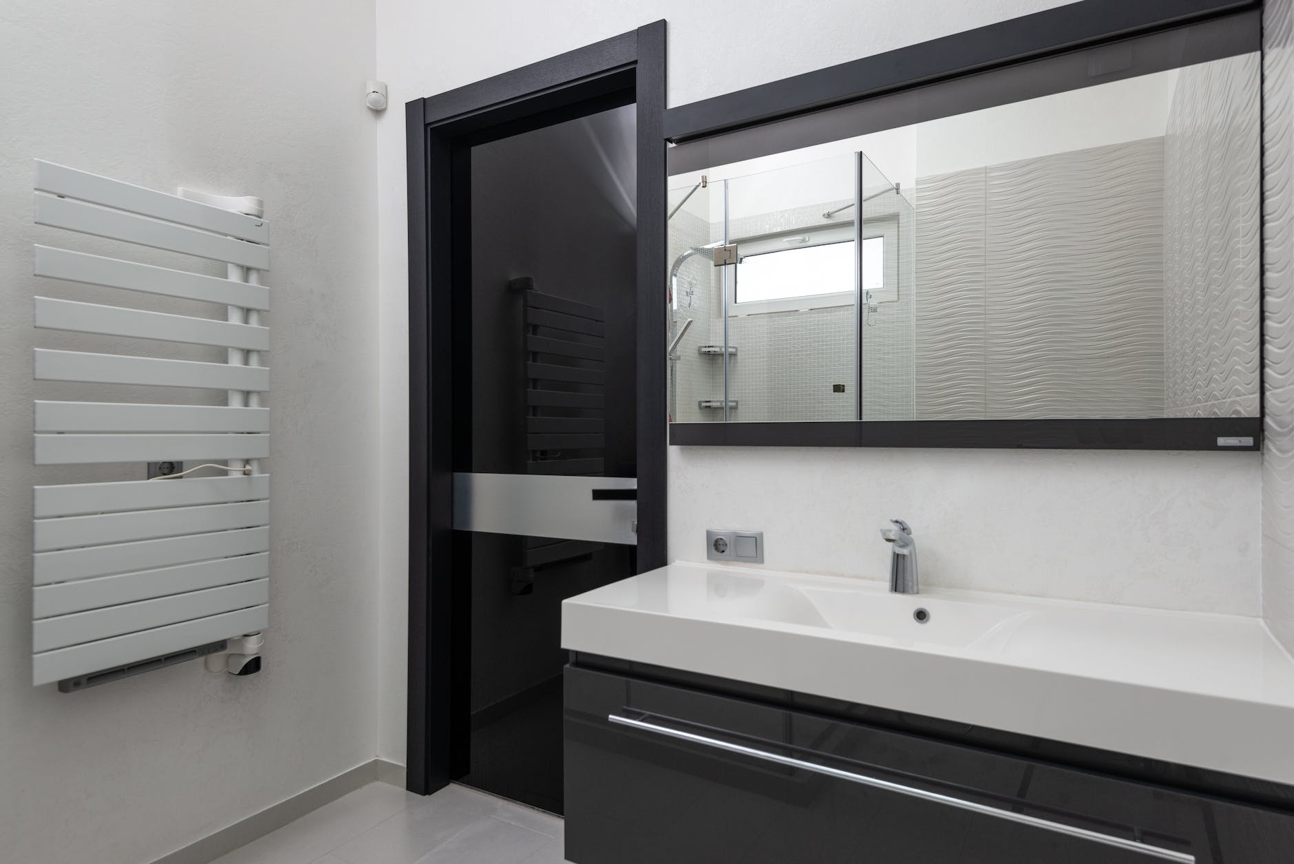 modern bathroom interior with washbasin under mirror at home