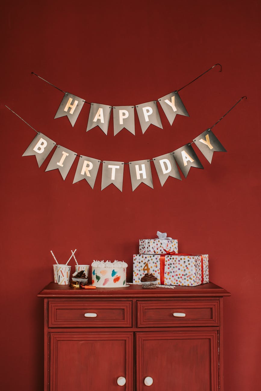 happy birthday banner on a red wall