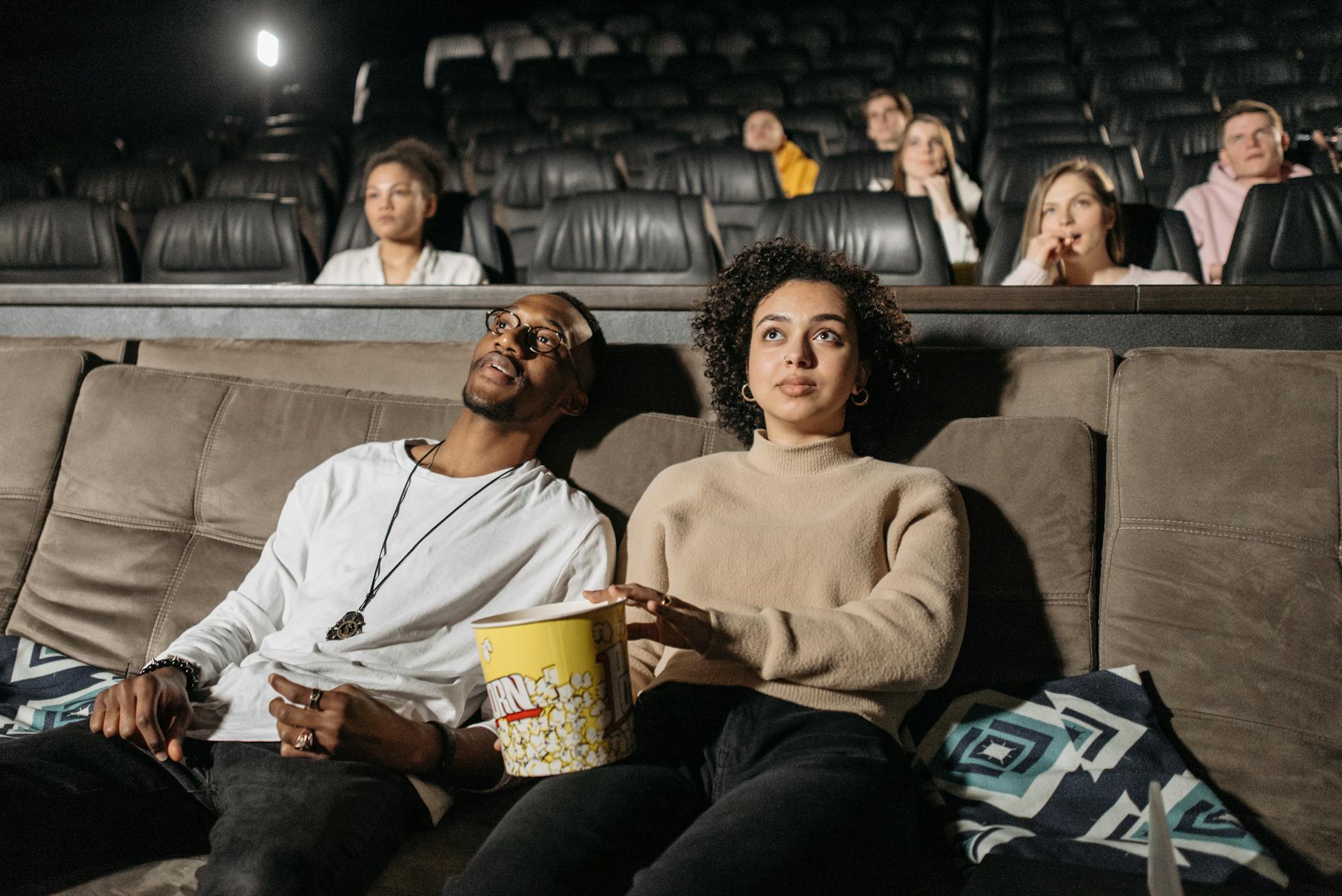 close up photo of a couple watching a movie together