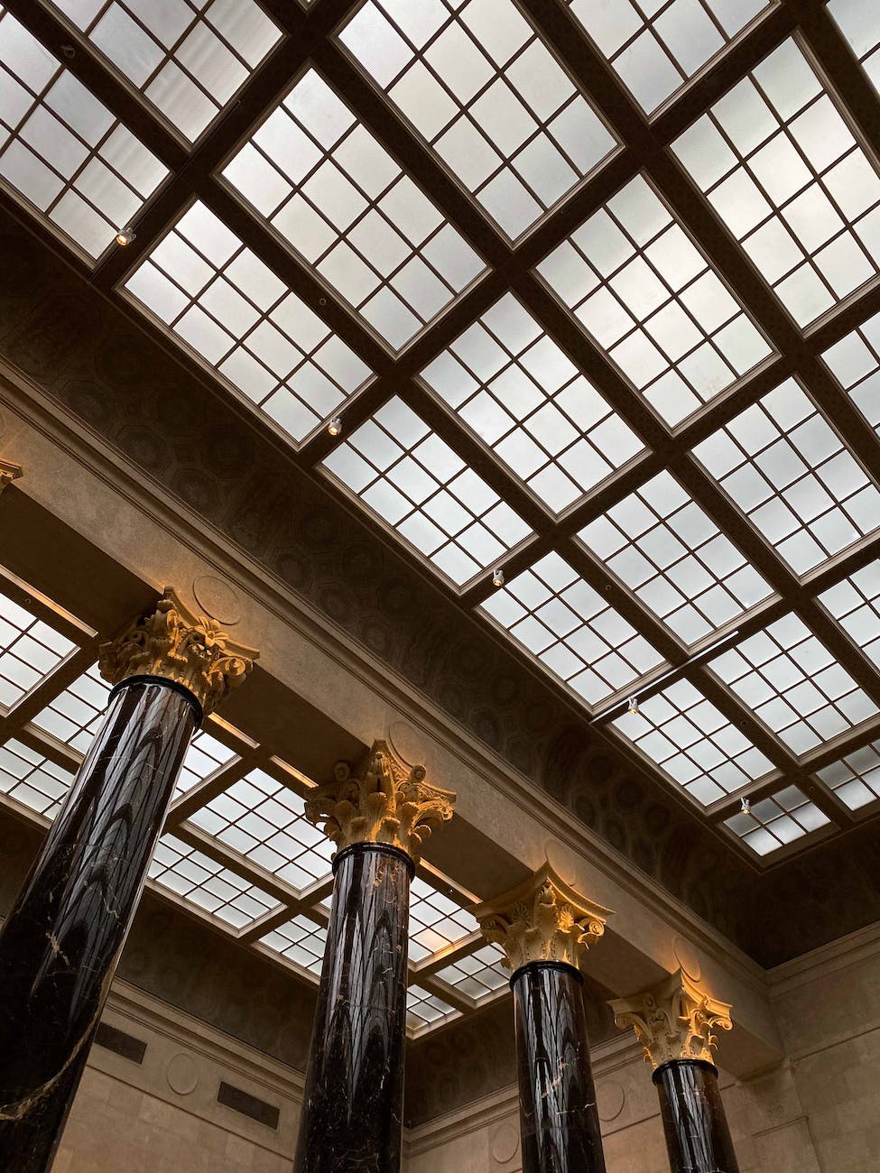 interior details of classic styled museum with columns and glass roof