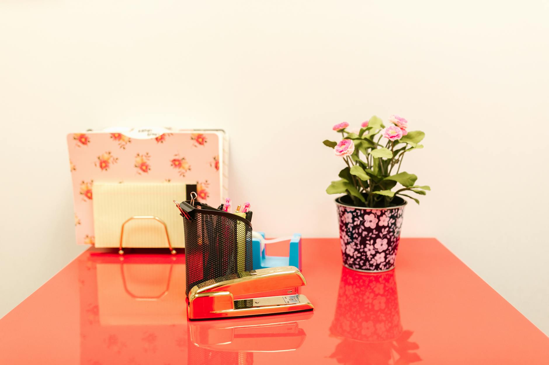 a table with stapler and plant