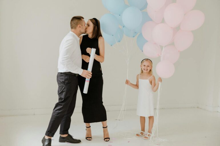 girl standing beside her parents