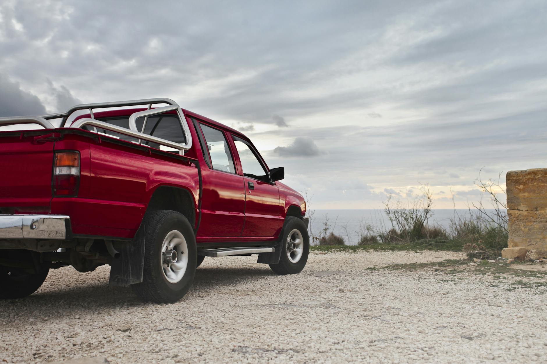 red pickup truck parked near wall