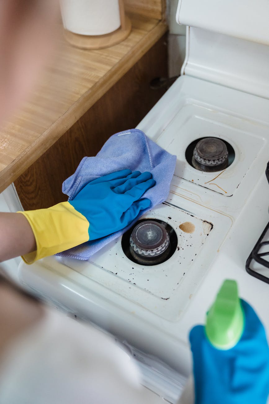 a person cleaning a gas stove