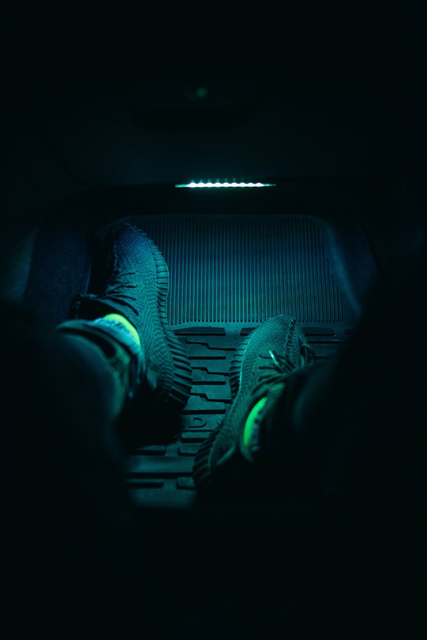 close up on legs on mat in car